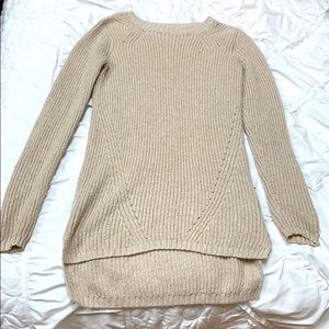 A knitted longer kind of sweater